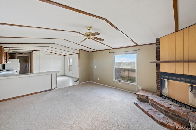 35275 Book Rd, Yoder, CO 80864 - unfurnished living room with lofted ceiling, ceiling fan, light colored carpet, and a brick fireplace