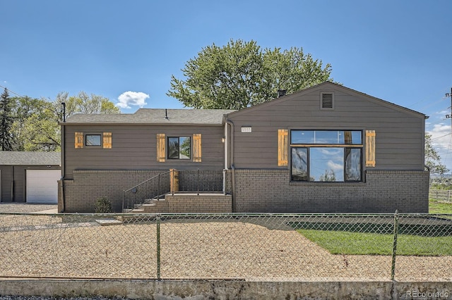 5555 Julian St, Denver, CO 80221 - view of front facade featuring brick siding and a fenced backyard