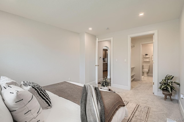 5555 Julian St, Denver, CO 80221 - bedroom with arched walkways, light colored carpet, recessed lighting, baseboards, and ensuite bath