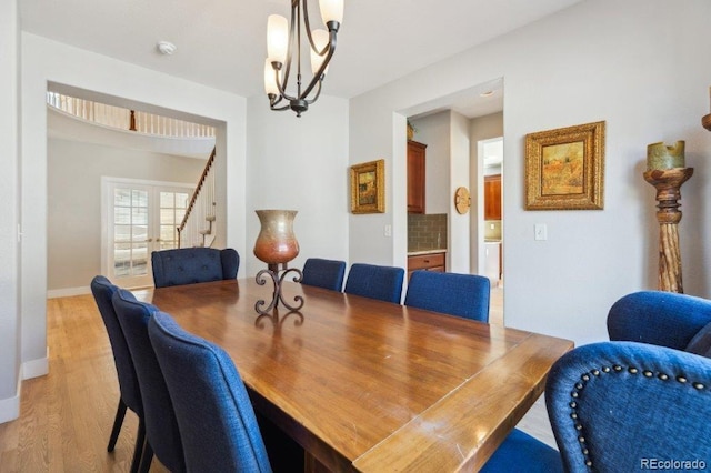3102 Fox Sedge Pl, Highlands Ranch, CO 80126 - dining room with light wood-style floors, stairway, baseboards, and a chandelier