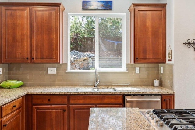 3102 Fox Sedge Pl, Highlands Ranch, CO 80126 - kitchen featuring a sink, stainless steel appliances, backsplash, and light stone counters