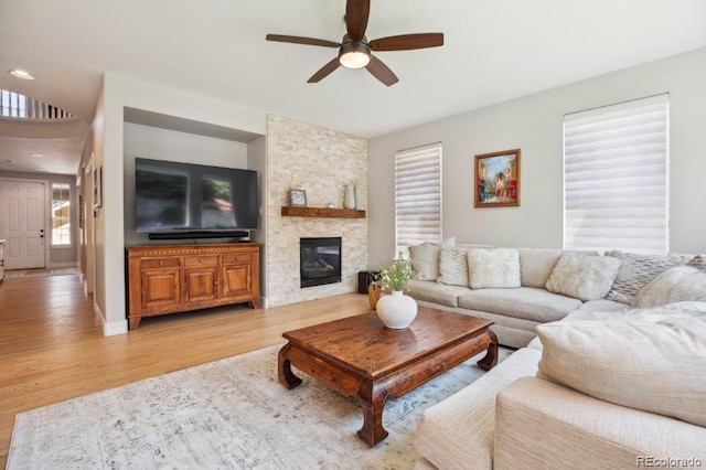3102 Fox Sedge Pl, Highlands Ranch, CO 80126 - living area with ceiling fan, light wood-type flooring, and a fireplace