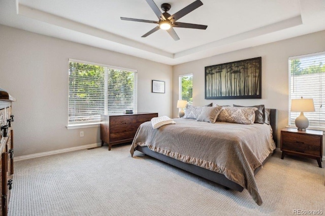 3102 Fox Sedge Pl, Highlands Ranch, CO 80126 - bedroom with a tray ceiling, light colored carpet, baseboards, and multiple windows