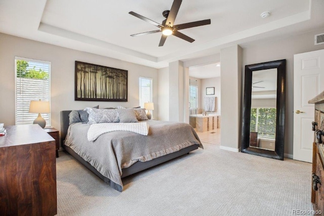 3102 Fox Sedge Pl, Highlands Ranch, CO 80126 - bedroom featuring a tray ceiling, light carpet, multiple windows, and baseboards