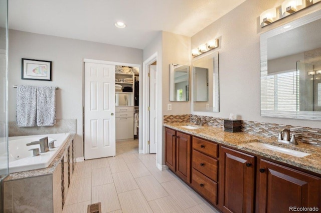 3102 Fox Sedge Pl, Highlands Ranch, CO 80126 - bathroom with double vanity, a jetted tub, a shower stall, a spacious closet, and recessed lighting