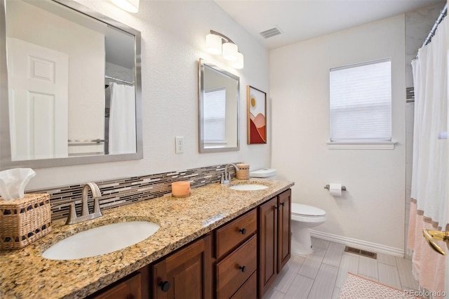 3102 Fox Sedge Pl, Highlands Ranch, CO 80126 - full bathroom with double vanity, baseboards, toilet, decorative backsplash, and a shower with curtain