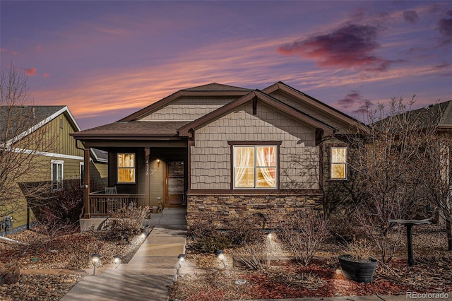 craftsman house with stone siding and a porch