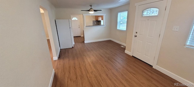 2880 W 91st Pl, Denver, CO 80260 - foyer entrance featuring wood finished floors, baseboards, arched walkways, and a ceiling fan