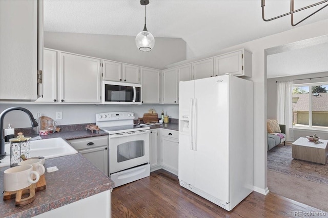 10895 W Bowles Pl, Littleton, CO 80127 - kitchen featuring white appliances, a sink, dark countertops, dark wood-type flooring, and vaulted ceiling