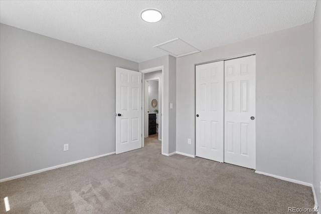 10895 W Bowles Pl, Littleton, CO 80127 - unfurnished bedroom featuring carpet flooring, attic access, baseboards, a closet, and a textured ceiling