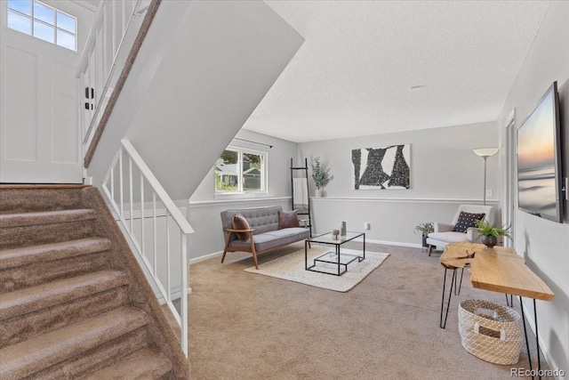 10895 W Bowles Pl, Littleton, CO 80127 - carpeted living room with stairway, plenty of natural light, a textured ceiling, and baseboards