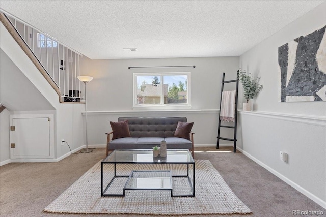 10895 W Bowles Pl, Littleton, CO 80127 - carpeted living area with plenty of natural light, a textured ceiling, baseboards, and stairs