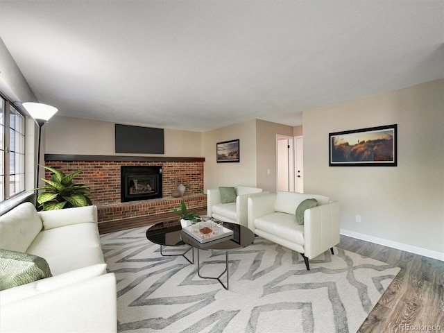 15915 E Mercer Cir, Aurora, CO 80013 - living area with wood finished floors and a brick fireplace
