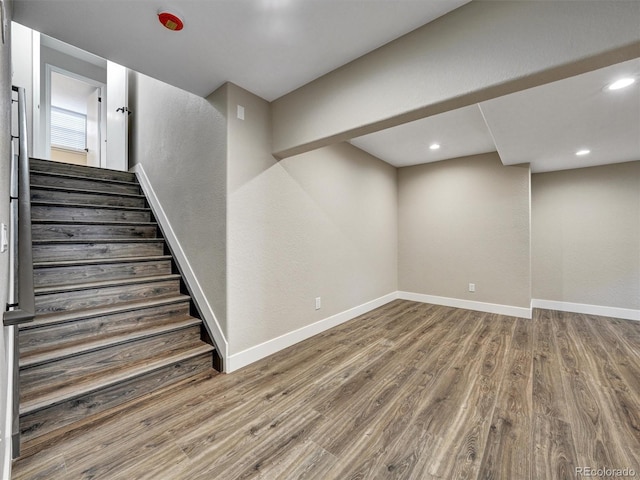 15915 E Mercer Cir, Aurora, CO 80013 - below grade area featuring wood finished floors, stairway, and recessed lighting
