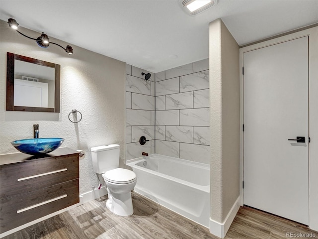 15915 E Mercer Cir, Aurora, CO 80013 - full bathroom with wood finished floors, vanity, bathtub / shower combination, and a textured wall