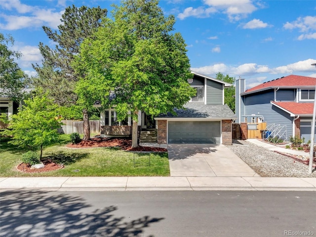 15915 E Mercer Cir, Aurora, CO 80013 - view of property hidden behind natural elements with brick siding, an attached garage, and driveway