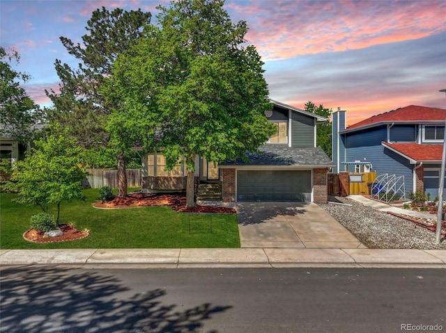 15915 E Mercer Cir, Aurora, CO 80013 - view of front of house with brick siding, a garage, and concrete driveway