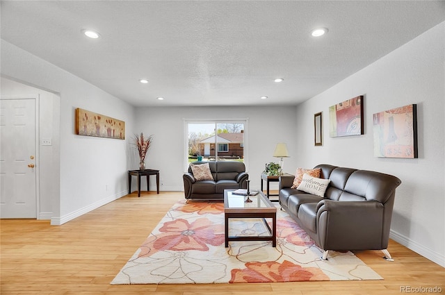 7819 Tejon St, Denver, CO 80221 - living area with light wood-style floors, a textured ceiling, and recessed lighting