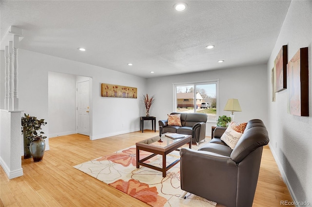 7819 Tejon St, Denver, CO 80221 - living area featuring light wood-type flooring, a textured ceiling, and recessed lighting