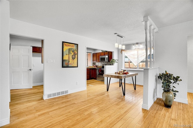 7819 Tejon St, Denver, CO 80221 - dining room featuring a textured ceiling and light wood-type flooring