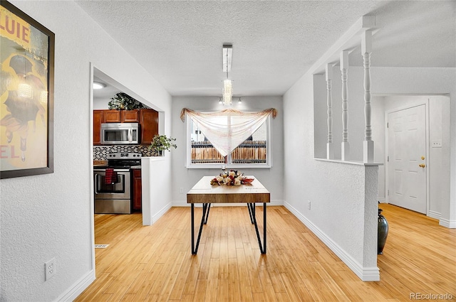 7819 Tejon St, Denver, CO 80221 - dining space featuring light wood-type flooring, a textured ceiling, and a textured wall