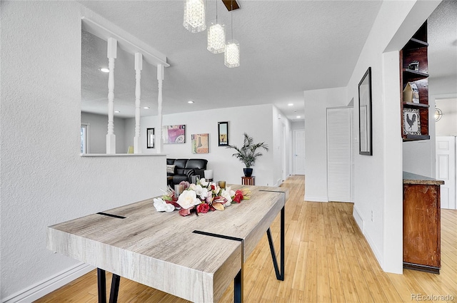7819 Tejon St, Denver, CO 80221 - dining space featuring light wood-type flooring, a textured ceiling, a textured wall, and recessed lighting