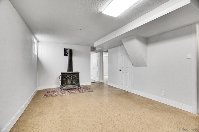 7819 Tejon St, Denver, CO 80221 - unfurnished living room featuring a wood stove and a textured ceiling