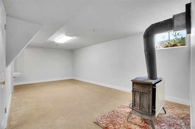 7819 Tejon St, Denver, CO 80221 - below grade area featuring a wood stove and baseboards