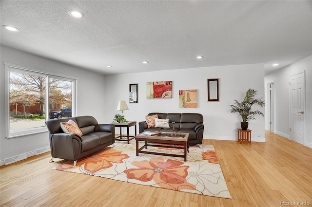 7819 Tejon St, Denver, CO 80221 - living area with light wood finished floors, recessed lighting, and a textured ceiling