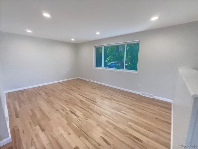 spare room with light hardwood / wood-style floors