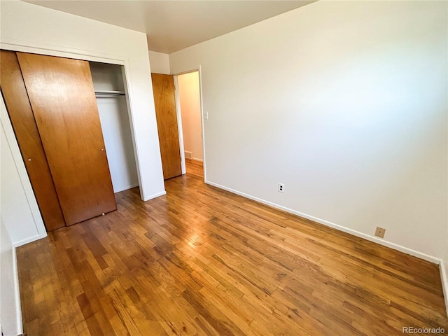 660 Wolff St, Denver, CO 80204 - unfurnished bedroom featuring wood finished floors, a closet, and baseboards