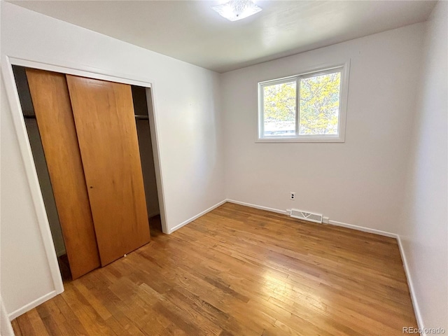 660 Wolff St, Denver, CO 80204 - unfurnished bedroom featuring light wood-style floors, a closet, and baseboards