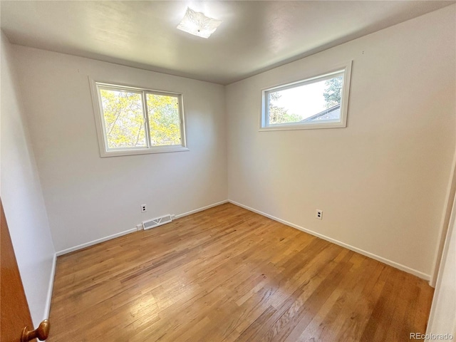 660 Wolff St, Denver, CO 80204 - spare room featuring plenty of natural light, light wood finished floors, and baseboards