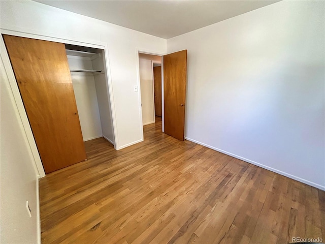 660 Wolff St, Denver, CO 80204 - unfurnished bedroom with wood finished floors, baseboards, and a closet