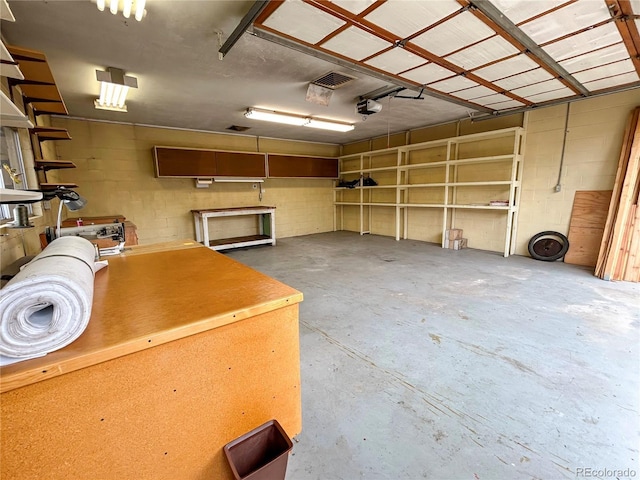 660 Wolff St, Denver, CO 80204 - garage featuring a garage door opener and concrete block wall