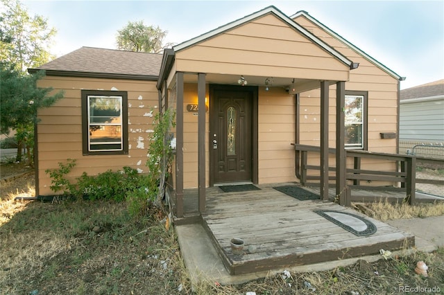 7261 Magnolia St, Commerce City, CO 80022 - property entrance with a shingled roof and a deck