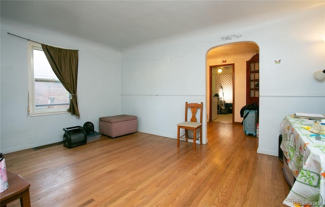 7261 Magnolia St, Commerce City, CO 80022 - spare room with baseboards, arched walkways, and light wood-type flooring