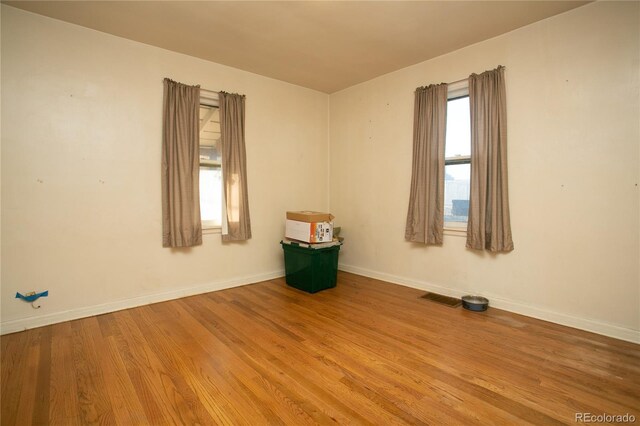 unfurnished room featuring hardwood / wood-style flooring