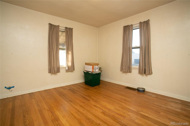 7261 Magnolia St, Commerce City, CO 80022 - empty room featuring visible vents, baseboards, and wood finished floors
