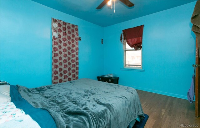 bedroom featuring ceiling fan and dark hardwood / wood-style flooring