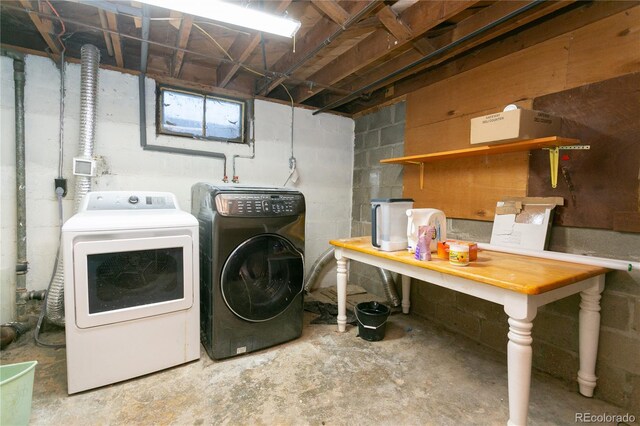 clothes washing area featuring washer and dryer