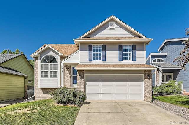 13069 Jackson Dr, Thornton, CO 80241 - view of front facade featuring brick siding, driveway, a garage, and a shingled roof