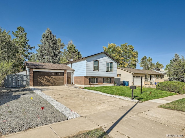 tri-level home with an outbuilding and a front lawn