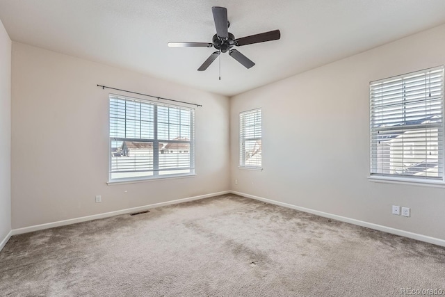 unfurnished room with ceiling fan and carpet floors