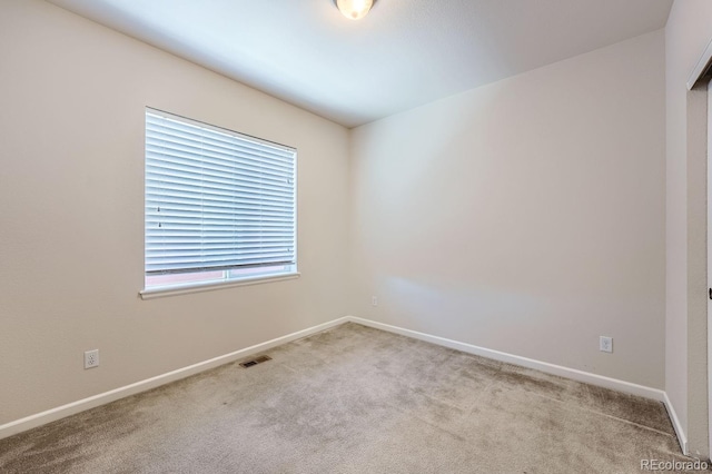 empty room featuring light carpet