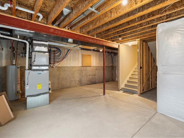 unfinished basement featuring heating unit, stairs, and gas water heater