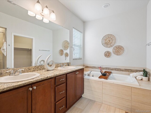 full bath with a garden tub, tile patterned flooring, a sink, and double vanity