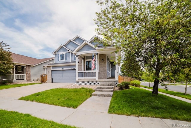 15389 E 99th Way, Commerce City, CO 80022 - view of front facade featuring brick siding, an attached garage, a porch, and a front yard