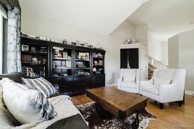15389 E 99th Way, Commerce City, CO 80022 - living room with wood finished floors, lofted ceiling, stairs, and baseboards