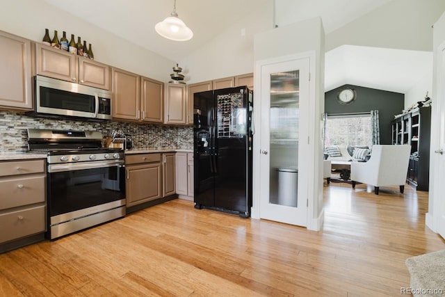 15389 E 99th Way, Commerce City, CO 80022 - kitchen with stainless steel appliances, lofted ceiling, tasteful backsplash, light wood-style flooring, and light countertops